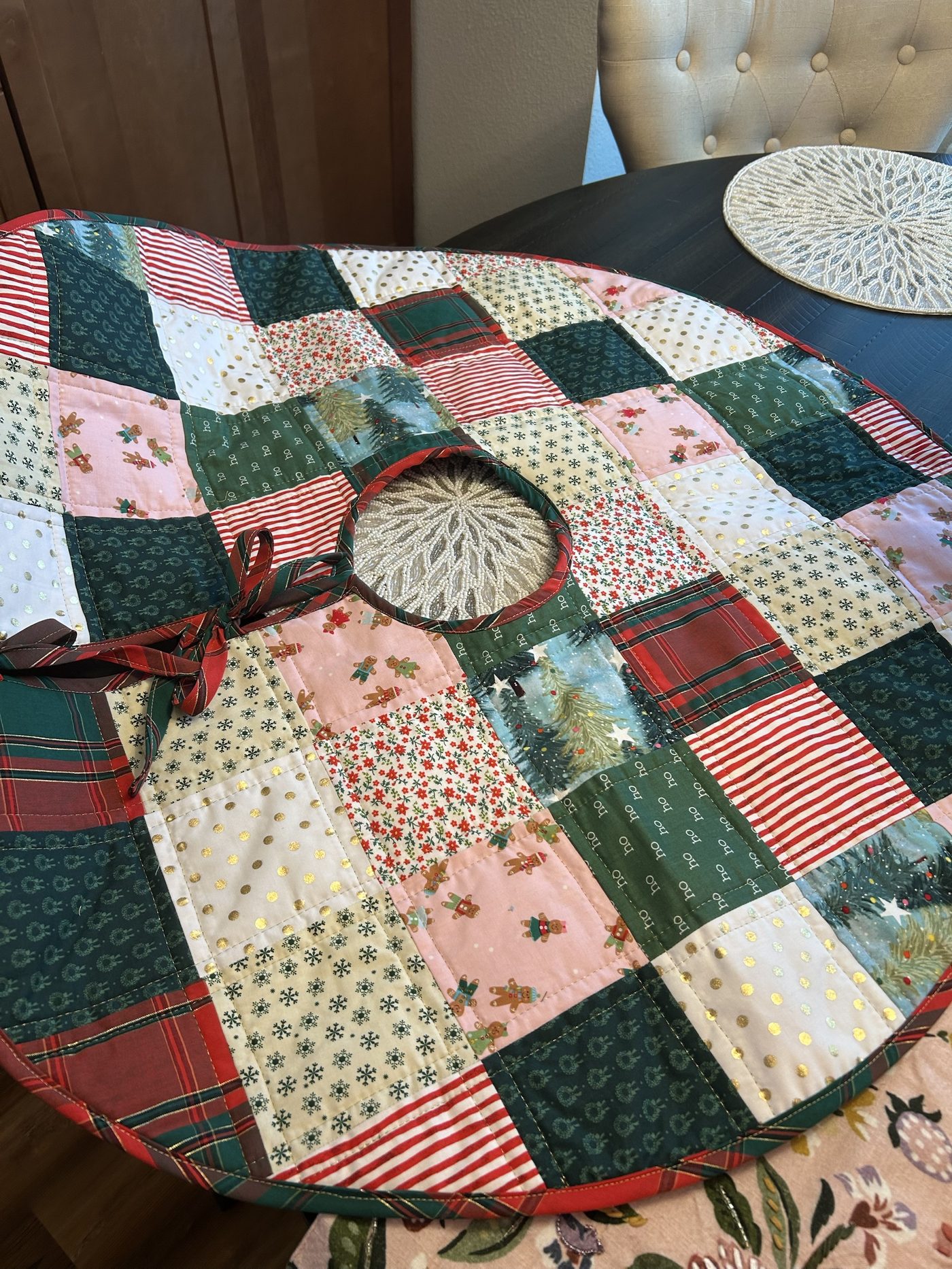 A round patchwork Christmas tree skirt in plaid, gingerbread and gold-dot fabrics